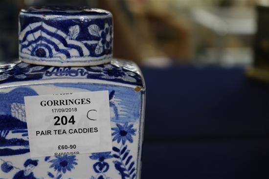A pair of Dutch delft blue and white lidded tea caddies